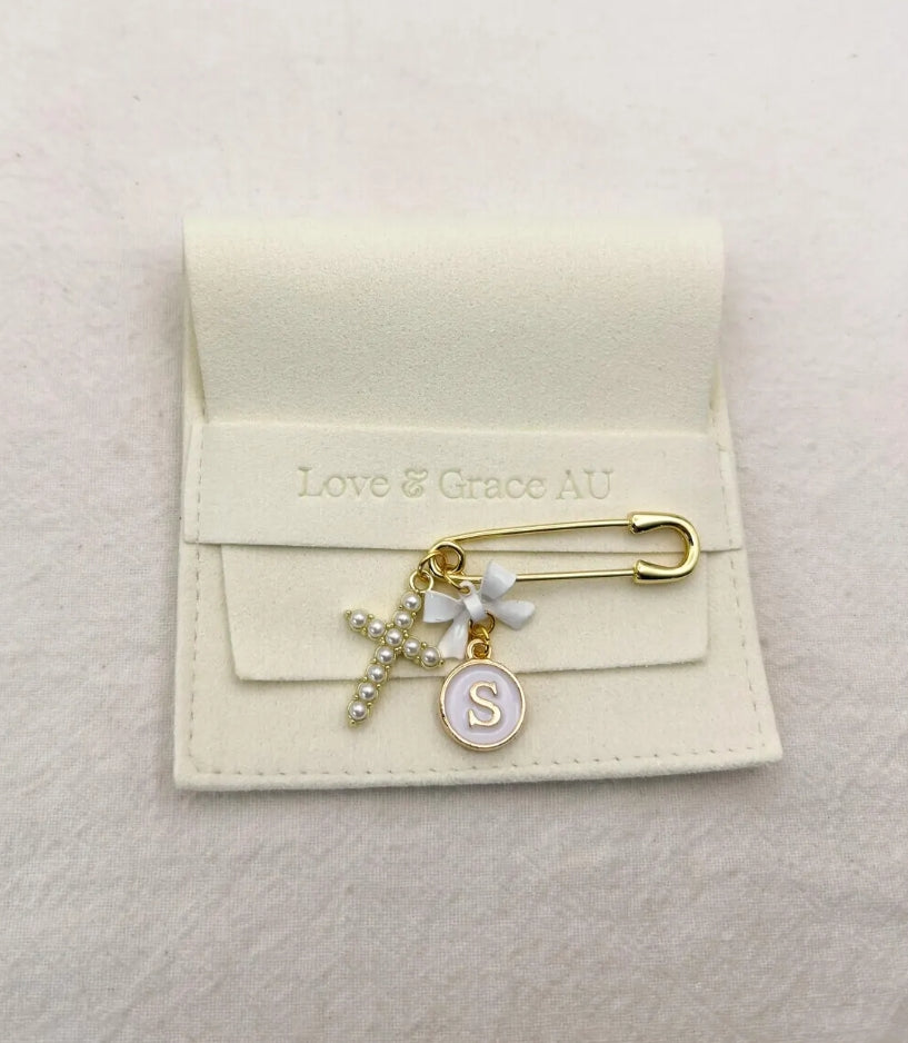 Small gold pin personalised with bow, letter charm and cross