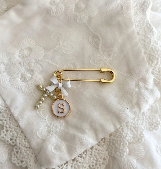 Small gold pin personalised with bow, letter charm and cross