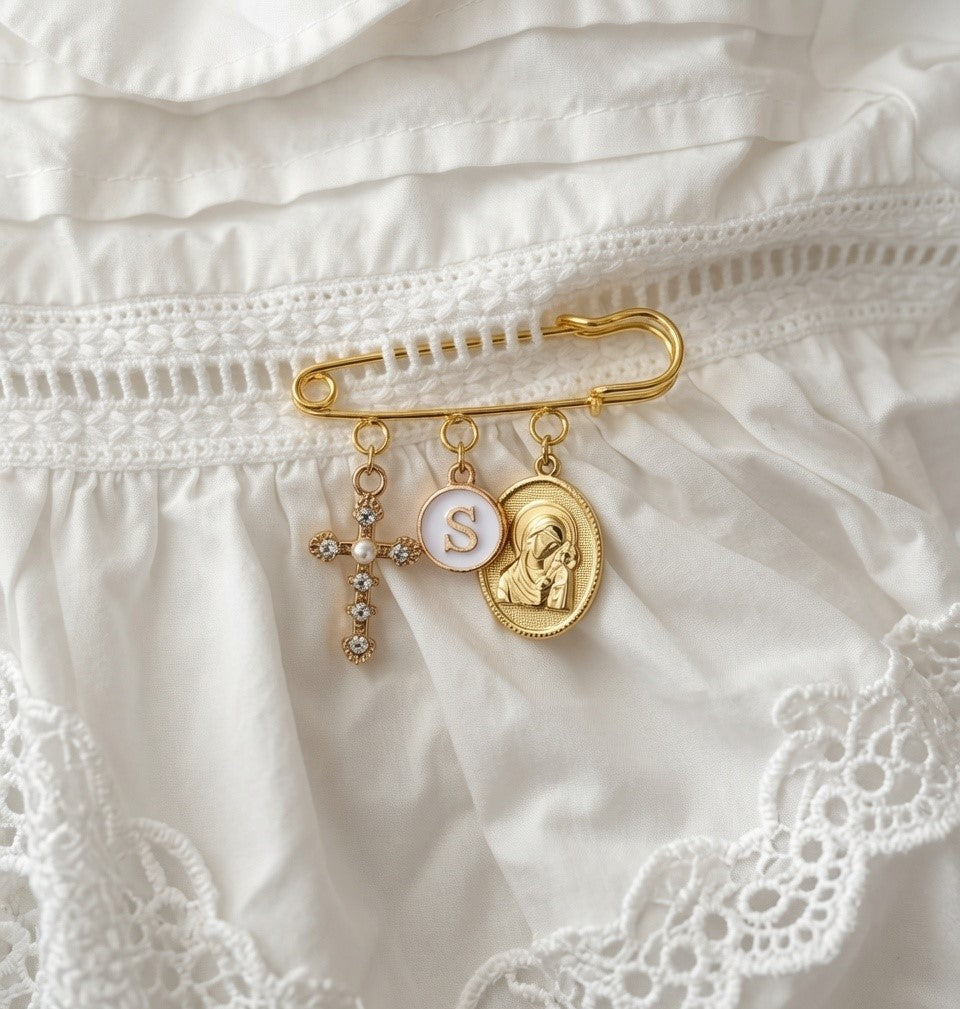 Orthodox Christian baby pin gold safety pin brooch featuring religious cross, custom personalised charms, Virgin Mary and baby Jesus pendant.